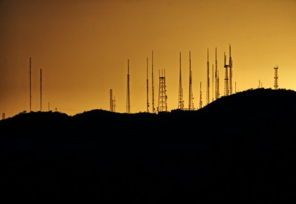 silhouette-photo-of-transmission-tower-on-hill-2525871